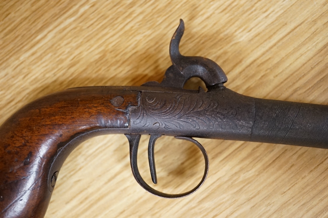 A boxlock percussion pocket pistol with turn off barrel etched with ribbon twist, engraved rounded frame, liege proved, with rounded walnut butt